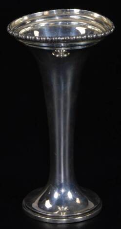 A George V silver specimen vase, of trumpet form with tapering stem and flared rim, on circular foot, London 1914, 18cm H, 13½oz (weighted).