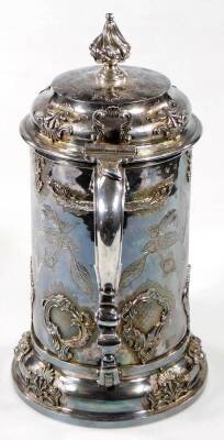 A William III and later silver ceremonial tankard, with design of a gadrooned flame finial, compressed domed lid, leafy capped thumb mould handle and applied and chased body, set with fern leaves and scrolls, on a shaped base set with satyr mask heads, in - 4