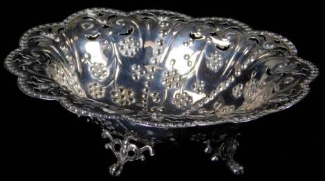 A Victorian silver bon bon basket, of oval floral form, raised with beads and flowers, with a pierced rim, on quadruple pierced ball and claw feet, London 1891, 16cm W, 3½oz.