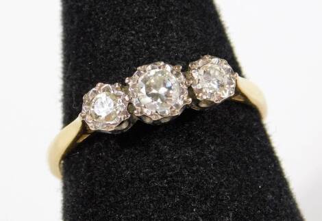 An 18ct gold three stone diamond ring, with three old cut diamonds, in claw setting, with two inset diamonds to each shoulder, ring size S, 2.7g all in.