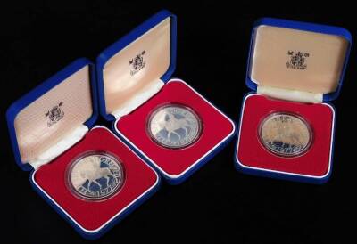 A Queen's Silver Jubilee silver proof crown, in box and outer packaging and two others. (3)