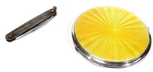 An Art Deco enamel and chrome plated powder compact, of circular form, 9cm Dia., with outer velvet case, and an engine turned silver double bladed pen knife. (2)