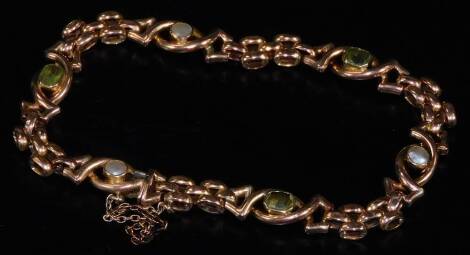 A fancy link bracelet, set with shaped sections broken by coloured stones marked 15ct, 18cm L, 13.5g all in. (in associated case)