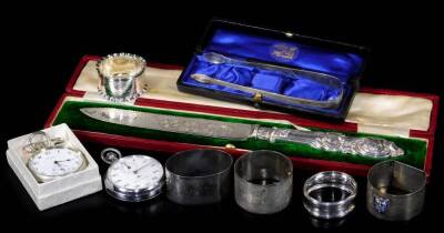 Various silver, silver plated ware, etc. to include napkin rings, 5cm Dia., plated Nero Lemania stop watch, silver plated open face pocket watch, cased ceremonial knife, sugar bows, etc. 8oz of silver all in. (a quantity, various dates)