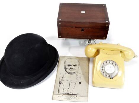 Bygones, collectables, etc. a yellow telephone with articulated front number ring, 14cm W, a rosewood jewellery box, bowler hat and a caricature of Winston Churchill awaiting election, mixed media. (4)