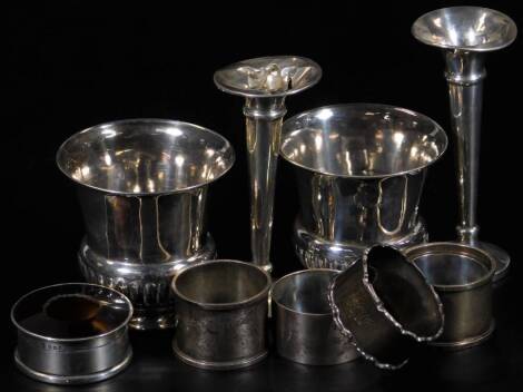 Various silver, comprising a pair of vases, each of part gadrooned trumpet form, London 1906, 8cm H, various napkin rings, jar with tortoiseshell style lid, weighted specimen vase and another similar, 11oz all in. (a quantity)