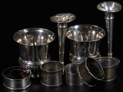 Various silver, comprising a pair of vases, each of part gadrooned trumpet form, London 1906, 8cm H, various napkin rings, jar with tortoiseshell style lid, weighted specimen vase and another similar, 11oz all in. (a quantity)