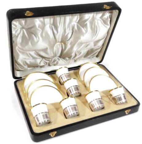 A cased set of six Shelley late Foley gilt rimmed coffee cups and saucers, by Mappin & Webb, with silver mounts, loop handles, upper and lower pierced banding, Sheffield 1913.