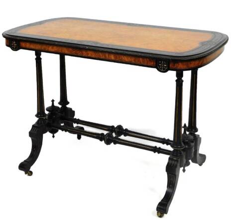 A 19thC amboyna ebonised and gilt wood side table, the oblong top with a beaded outline and bellflower decoration, on quadruple turned reeded legs joined by turned cylindrical stretchers, on scroll feet terminating in castors, 73cm H, 102cm W, 57cm D.