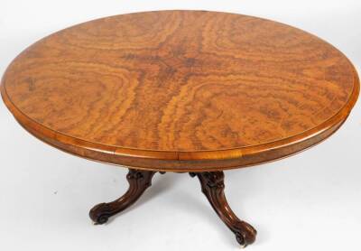 A Victorian walnut and string inlaid loo table, of oval form, on a heavy baluster stem terminating in quadruple carved cabriole legs with scroll feet, terminating in castors, 82cm H, 147cm W, 115cm D. - 2