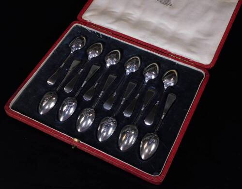 A set of George V silver teaspoons, old English pattern, raised with oriental figures to each bowl, 12cm W, 5½oz, in red Moroccan leather case marked Curtis & Horspool.