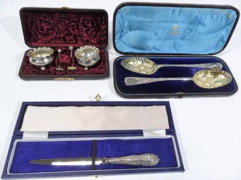 A pair of William IV silver and silver gilt berry spoons, old English pattern, with etched blades and raised bowls, London 1835, 23cm W, 4oz, a pair of open silver plated salts and a silver handled paper knife. (3, cased)