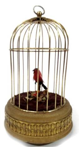 A 20thC bird cage automaton, the articulated bird in black and red colour way, 26cm H.