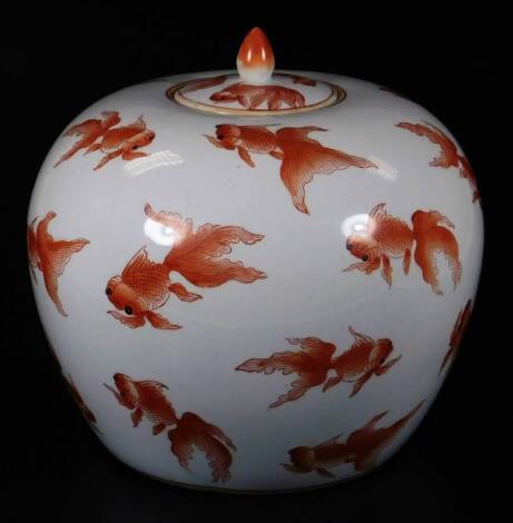 A 20thC Chinese porcelain fish jar and cover, of bulbous form, decorated with fish on a white ground, seal mark beneath, 32cm H.