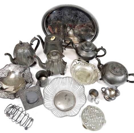 Various pewter, metalware, silver plated ware, etc. a gallery edged tray of oval form, partially gadrooned with pierced sides, 41cm W, basket, photograph frame, pewter, bullet shaped teapot, etc. (a quantity)