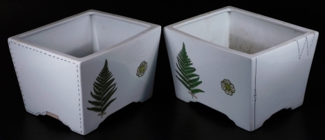 A pair of Fabienne Juvin pottery planters, each of rectangular form, sparsely decorated with ferns and other flowerheads, marked beneath, 26cm W. (2)