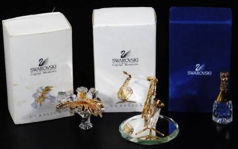 A boxed Swarovski crystal champagne bottle, 7cm H, brooch and mirrors. (3)