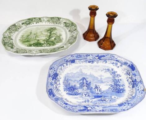 A 19thC blue and white transfer printed meat platter, of octagonal form, decorated with figures before building, with floral border, 50cm W, a green transfer printed meat dish, each with drainer and veined centre and two Davidson style candlesticks. (4)