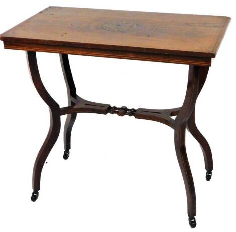 An Edwardian rosewood occasional table, the rectangular top inlaid with a floral patera, on inverted legs, joined by an elaborate stretcher, on castors, 68cm H, 76cm W, 44cm D.