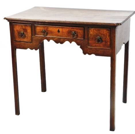 An early 19thC oak low boy, the rectangular moulded top raised above a carved frieze set with three drawers, on square legs, 72cm H, 82cm W, 51cm D.