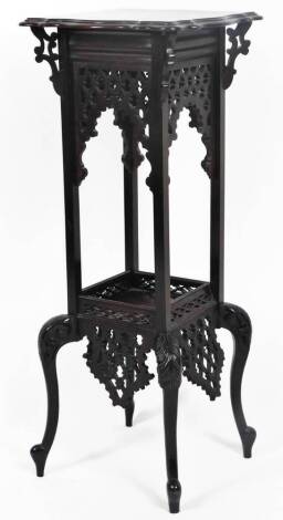 An Edwardian mahogany plant stand, the shaped square moulded top raised above a carved lattice work and galleried under section, with heavily carved cabriole legs terminating in cylindrical feet, 95cm H, 37cm W, 37cm D.