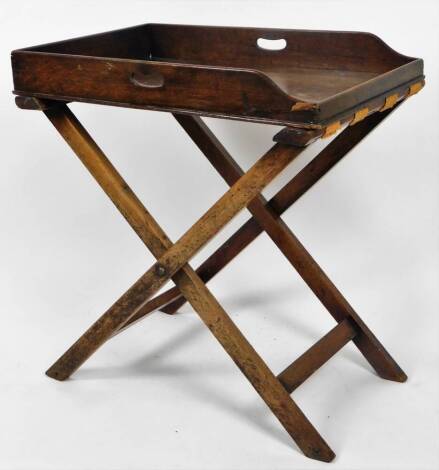 A 19thC oak butler's tray on stand, the rectangular galleried top with pierced handles, on an X framed stand with hessian supports, 77cm W.