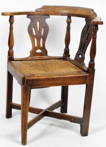 A late 19thC ash and elm corner chair, with rush seat and square legs joined by an X stretcher, 90cm H.