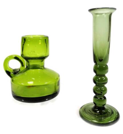 A green glass candlestick or vase, with cylindrical top, plain handle and compressed circular body, rough pontil, 11cm H, and a slender glass with bobbin turned stem, on circular foot. (2)