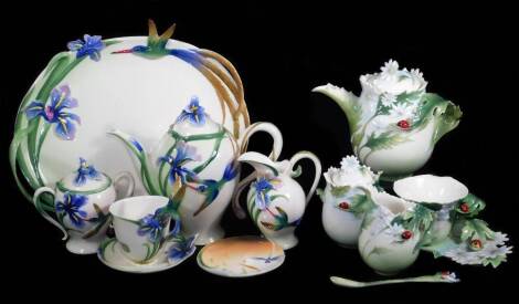 A Franz part service, raised with irises, predominately in blue and green, comprising tray, 33cm W, coffee pot milk jug, sugar bowl, cup and saucer, marked beneath, and another part service decorated with ladybirds. (a quantity)