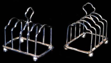 A pair of George V silver miniature toast racks, each with four sections centred by cloverleaf handles on orb feet, Sheffield 1932, 6cm H, 2½oz. (2)