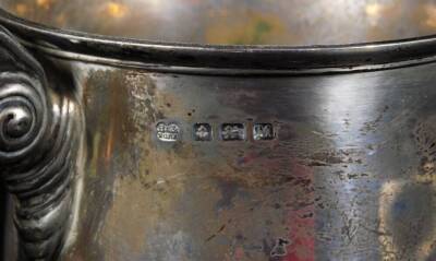 A George V silver trophy, the bell shaped bowl flanked by scroll handles on an ebonised plinth base, Birmingham 1936, 18cm H, 12½oz all in. - 2