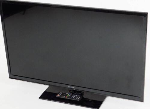 A Panasonic 29 inch colour television, in black trim with remote control and wire.