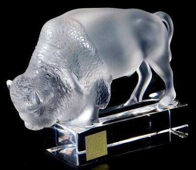 A 20thC crystal Lalique glass figure of a bison, in frosted and clear glass, labelled with etched mark beneath, 10cm H.