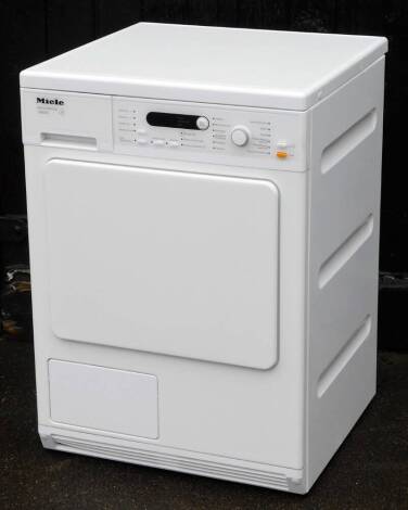 A Miele Honeycomb T8822C tumble dryer, 85cm H, 60cm W, 57cm D.