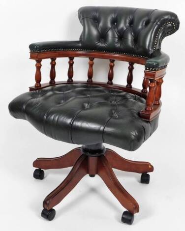 A late 20thC captain's office chair, with buttoned leather back, seat and plain arms, on a compressed stem terminating in quadruple sabre legs, on castors, with swivel action, 98cm H.