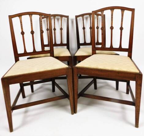 A set of four mahogany Sheraton design dining chairs, each with triple bellflower vertical splats broken by circular patera, on square tapering front legs joined by a H stretcher, with drop in seats in later material, 95cm H.