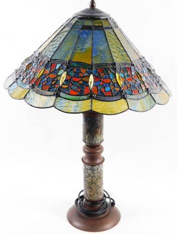 A Tiffany style lamp, with large shade decorated in coloured glass, on turned base lamp stand with two lights, on turned stem and circular foot, 78cm H.