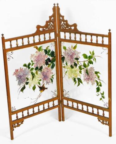 A 20thC oriental two fold screen, with buttress top, urn supports and double glass panels decorated with flowers, 92cm H.