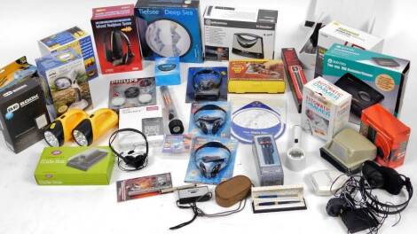 Various gadgets, electrical items, etc. to include Vision Booster Magnifier, KW radio, a Tiefsee Deep Sea sand picture, TV sound box, two flash lights, ballpoint pen, Science Museum Voice Travel Mate, slide box, headphones and transmitter, wireless ampli