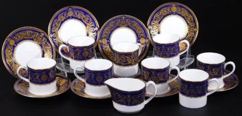 A Royal Worcester Sandringham pattern part coffee service, comprising milk jug, 7cm H, coffee cans and saucers, with gilt highlights, on a blue and white ground, printed marks beneath. (a quantity)