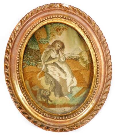 An 18thC stump work and silk picture, of a girl aside dog with tree and hills in the distance, in an oval frame, 14cm x 10cm.