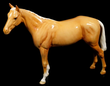 A Beswick pottery Palomino bay hunter, printed marks beneath, 21cm H.