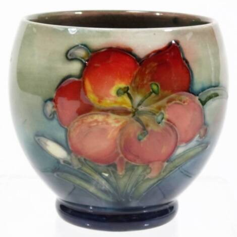 An early 20thC Moorcroft Freesia pattern bowl, of globular form, on circular foot, with late Queen Mary label, 8cm H.