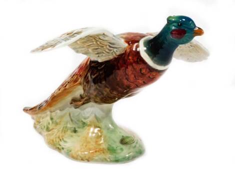 A Beswick figure of a pheasant, with winged outstretched, no. 850, impressed marks beneath, 13cm H.