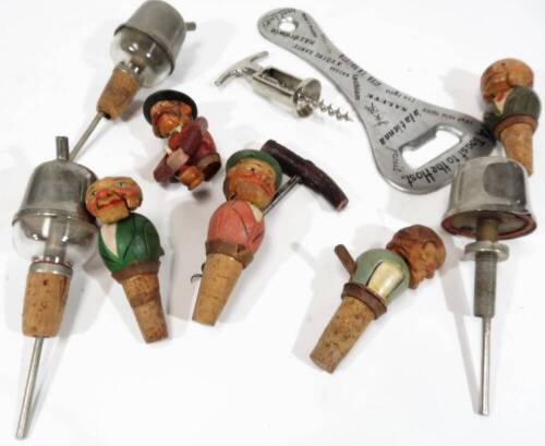 Various Scandinavian carved wooden cork stoppers, bottles stoppers, etc. to include articulated examples, gentleman with moustache holding bottle, 9cm H, other carved examples, chrome plated corkscrew, an enlarged bottle opener a toast to the host, etc.