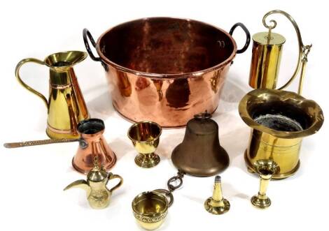 Various metalware, comprising a late 19thC copper vessel with raised iron handles, 40cm Dia., a trench art vase, brass jug with copper banding, jug with side handle, heavy iron bell, a trench art gong, various other metalware ornaments, brass ware, etc. 