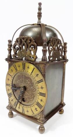 A 20thC Empire lantern clock, of rectangular form with bell top and 12cm Dia. Roman numeric dial, on turned feet, 27cm H.