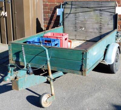 A two wheel trailer, of rectangular form with raised back, 116cm W, the wheels 144cm W.