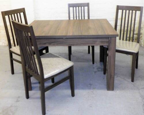 A set of four ex-display dining chairs, with original plastic coverings, 95cm H. and a table.