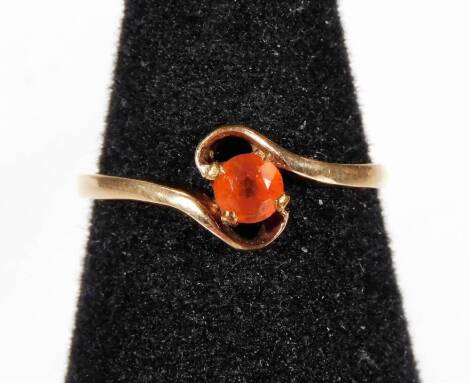 A 9ct gold dress ring, set with single orange opal in claw setting, on a twist design setting, ring size O½, 1.4g all in.